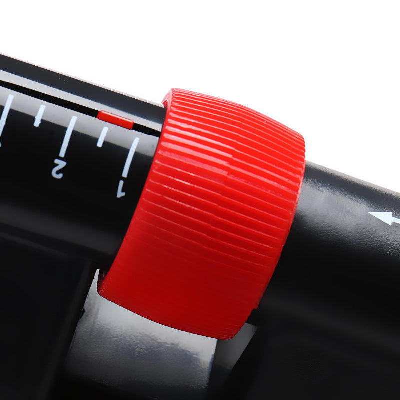 Close-up of a red knob on a black cylindrical object with measurement markings.