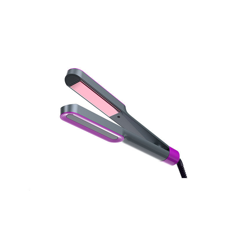 Warm curling hair straightener showcasing a sleek design with pink ceramic plates and ergonomic grip.