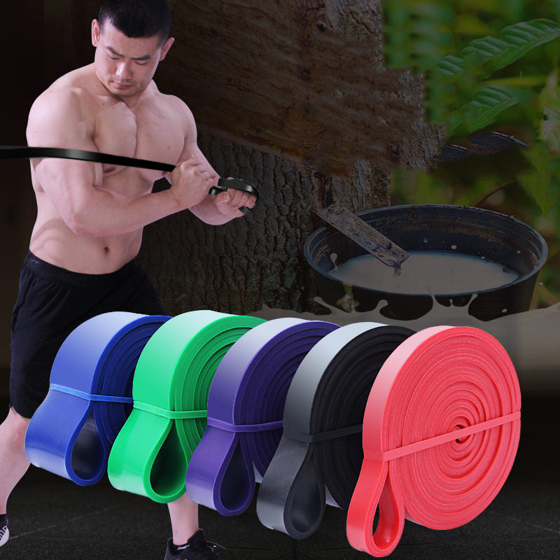 Man using resistance bands with a natural outdoor background