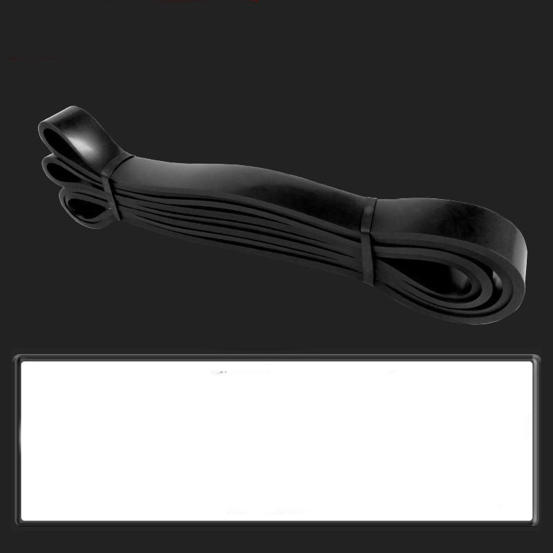 Black rubber band on a black background with a white label.
