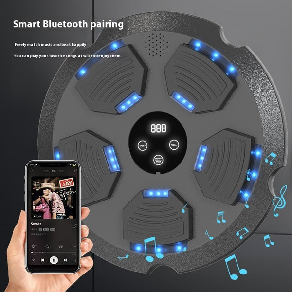 Round electronic device with blue lights and a smartphone displaying music app on a dark background