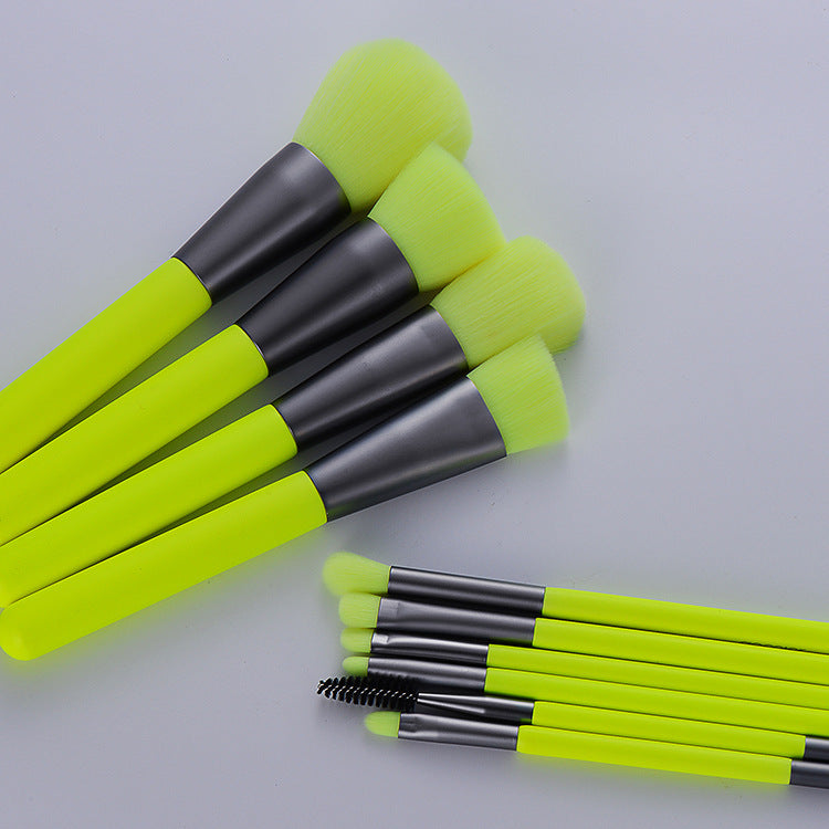 Professional neon makeup brushes featuring bright fluorescent green handles and soft bristles in a stylish arrangement.