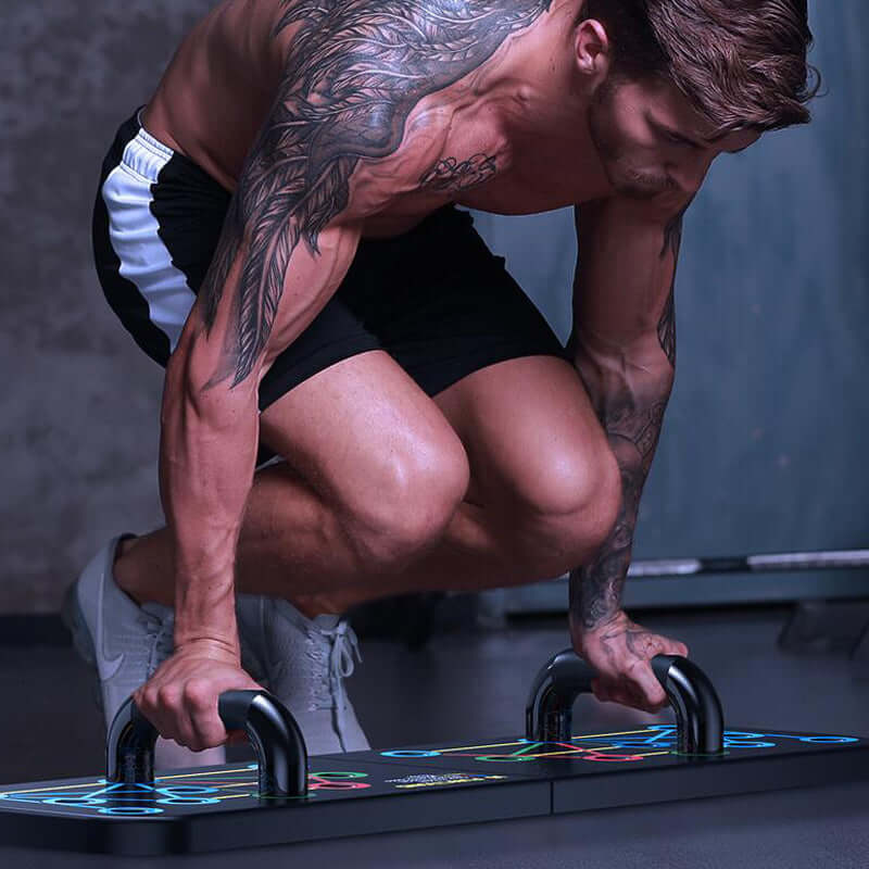 Athlete performing push-ups on a colorful platform with tattoos visible